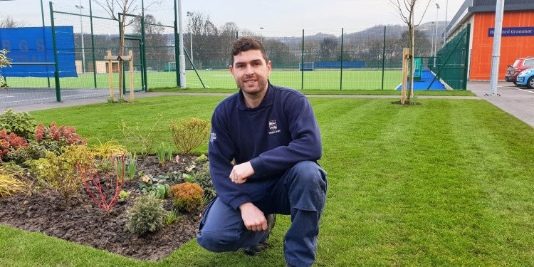 Lewis Pattinson in front of the new hockey pitch.jpg
