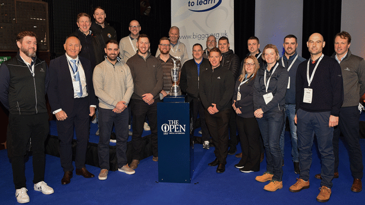 Previous-members-of-The-Open-Volunteer-Support-Team-joinerd-the-Claret-Jug-on-stage-at-BTME-in-January.gif