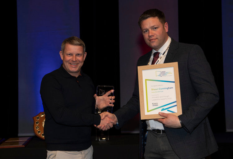 Shaun Cunningham (left) was presented with the Innovation and Thought Leadership Award by Lee Morgado of Campey Turf Care Systems.jpg